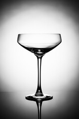 Empty alcohol glasses silhouette on a light background.