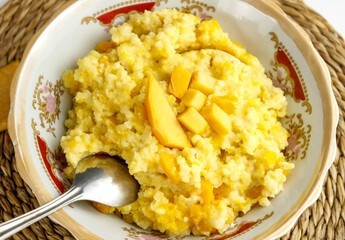 Pumpkin porridge with millet in a plate.