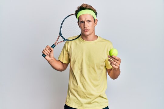 Handsome Caucasian Man Playing Tennis Holding Racket And Ball Thinking Attitude And Sober Expression Looking Self Confident
