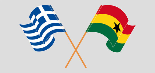 Crossed and waving flags of Greece and Ghana