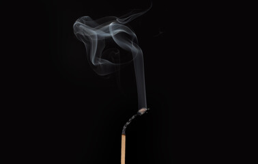 Ignition of match with smoke, isolated on black background. Match just after burning.