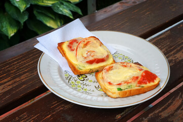 Toasted bread with cheese and tomatoes.