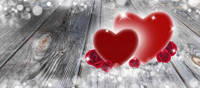 Two hearts and roses on a wooden background and white bokeh for Valentine's Day.