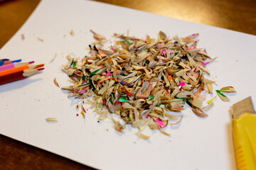 Colored pencils, shavings and a stationery knife