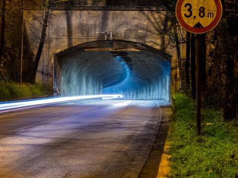 A closeup of a highway tunnel with a light trail