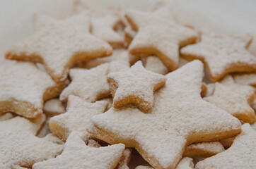 Christmas shortbread cookies in the shape of a star with a white sprinkle