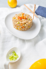 Fried rice dish with vegetables such as squash, carrots, bell peppers and Chinese spices.