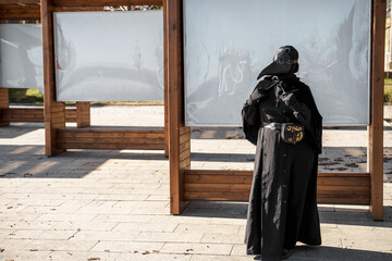 plague doctor stands at empty stands