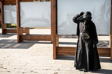 plague doctor stands at empty stands