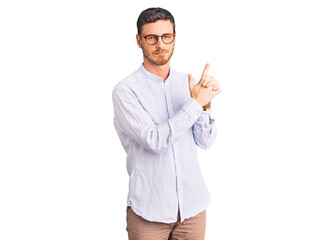 Handsome young man with bear wearing elegant business shirt and glasses holding symbolic gun with...