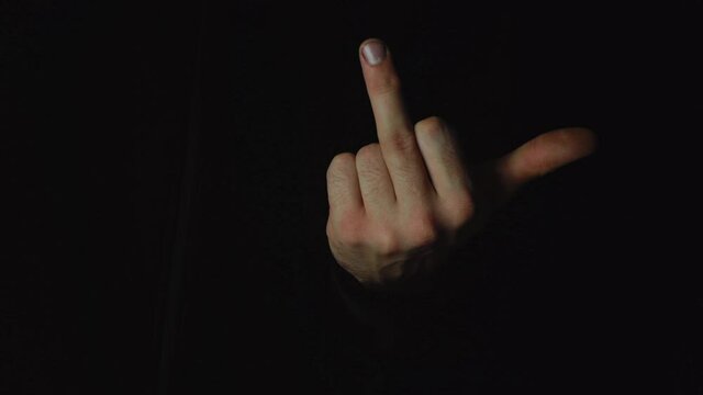 Meaning of Male Gesture in Western Cultures Fuck you or fuck you on isolated black screen