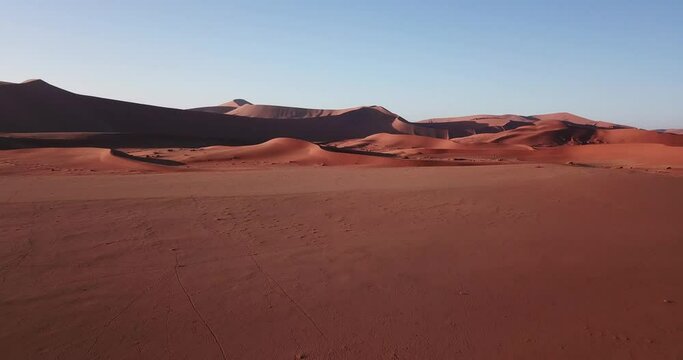 4K aerial drone footage of famous endless sand sea and Sossusvlei Namib Desert scenic red sand dunes on sunny morning in Namib-Naukluft Park in Namibia, southern Africa