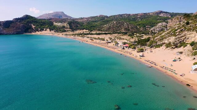 Tsampika beach with golden sand view from above, Rhodes, Greece. Aerial birds eye view of famous beach of Tsampika, Rhodes island, Dodecanese, Greece