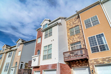 Townhouses on a sunny day setting with balconies overlooking scenic skyscape