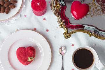 Red heart glazed cake and a cup of aromatic strong coffee. Romantic festive breakfast on...