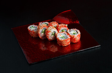 Asian cuisine dish, delicious sushi, sushi on a black background, roll you net on a black background