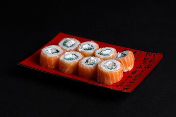 Asian cuisine dish, delicious sushi, sushi on a black background, roll you net on a black background