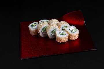 Asian cuisine dish, delicious sushi, sushi on a black background, roll you net on a black background