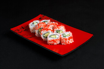 Asian cuisine dish, delicious sushi, sushi on a black background, roll you net on a black background