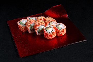 Asian cuisine dish, delicious sushi, sushi on a black background, roll you net on a black background