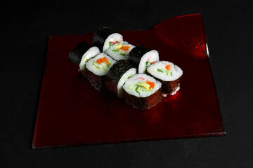 Asian cuisine dish, delicious sushi, sushi on a black background, roll you net on a black background