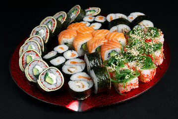 Asian cuisine dish, delicious sushi, sushi on a black background, roll you net on a black background,