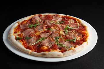 fragrant and hot pizza on a dark background
