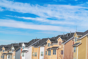 Townhouses exterior in the valley against skyscape of blue sky and clouds
