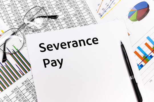 Text Severance Pay on paper with pen, glasess and charts