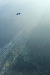 Wingsuit flier glides high above land