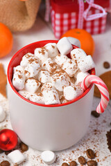 sweet food top view background for merry christmas or new year holiday decoration - chocolate candies, tangerines, cookies, marshmallow and cocoa latte on white wood