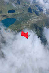 Wingsuit flier glides high above land