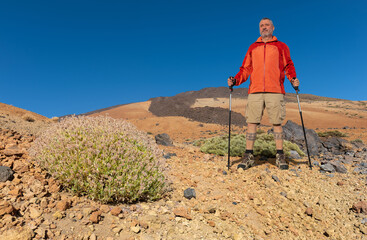 A mountain hiker with socks stands in front of the highest mountain in Spain on the Atlantic island...