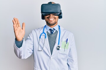 Young arab doctor man smiling happy wearing uniform and using 3d glasses over isolated white background.