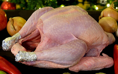 raw turkey for christmas or thanksgiving with vegetables