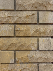 Solid piece of beige brick wall. brickwork for background or texture, dark spots on brickwork