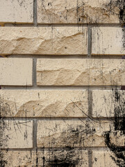 Solid piece of beige brick wall. brickwork for background or texture, dark spots on brickwork
