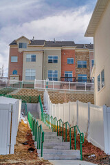 Stairways and houses at a peaceful neighborhood with cloudy blue sky overhead