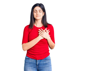 Young beautiful girl wearing casual t shirt smiling with hands on chest with closed eyes and grateful gesture on face. health concept.