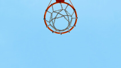 Basketball Hoop On Sports Court Against Blue Sky in the background.