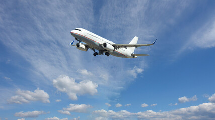 Fototapeta na wymiar Zoom photo of latest technology passenger airplane flying in deep blue slightly cloudy sky