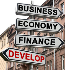 The road indicator on the arrows of which is written - business, economics, finance and DEVELOP
