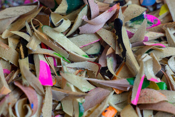 Shavings of colored pencils on a white background. Macro shooting.