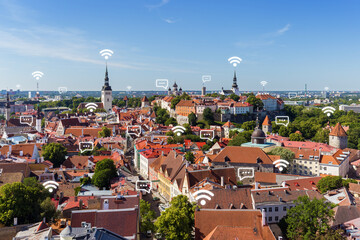 Historic churches, other landmarks and old buildings at the Old Town in Tallinn, Estonia, viewed from above in the summer. Wireless network connection, WiFi, smart city and online messaging concept.