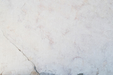 Close-up of an aged and cracked smooth natural marble stone wall or flooring. High resolution full frame textured background.