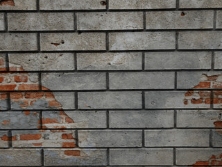 A solid piece of brown brick wall. brickwork for the background or texture, sometimes the brickwork is destroyed