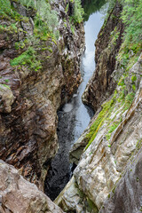 Canyon with a steep rock face and small creek