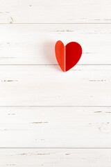 Red heart on a white wooden background from shabby boards. Minimalism concept, declaration of love. Valentine's Day, Mother's Day, Wedding. Ready romantic greeting card with copy space