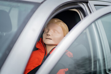 Dummy is sitting on the driver seat during prosessional first aid course