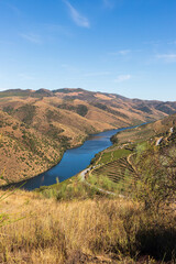 Fototapeta na wymiar The Côa River at Vila Nova de Foz Côa, Portugal, against blue sky
